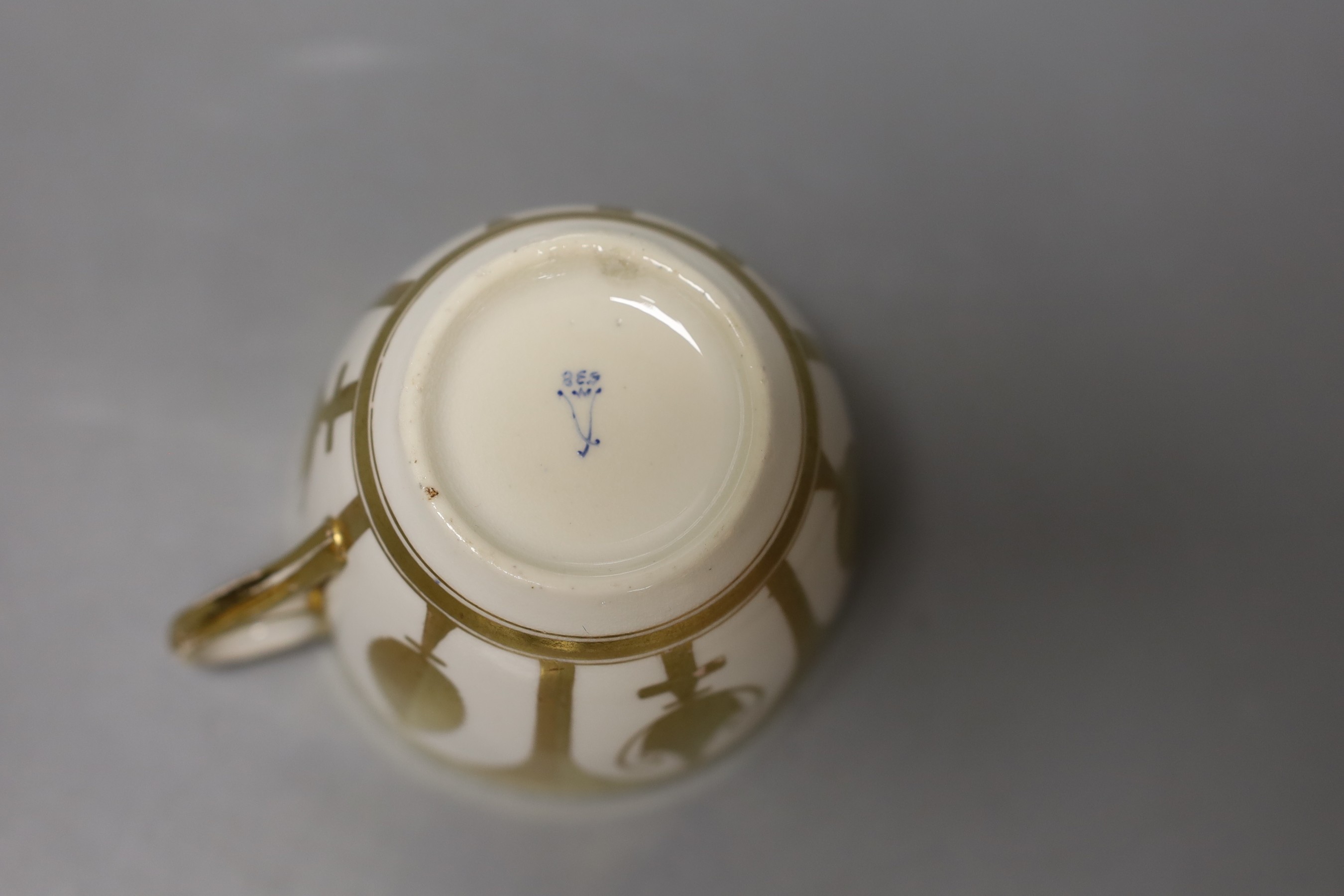 Minton rare early cup and saucer gilded in neo-classical style leaves and urns pattern 238, Sevres style mark with letter 'M' and 238 in blue